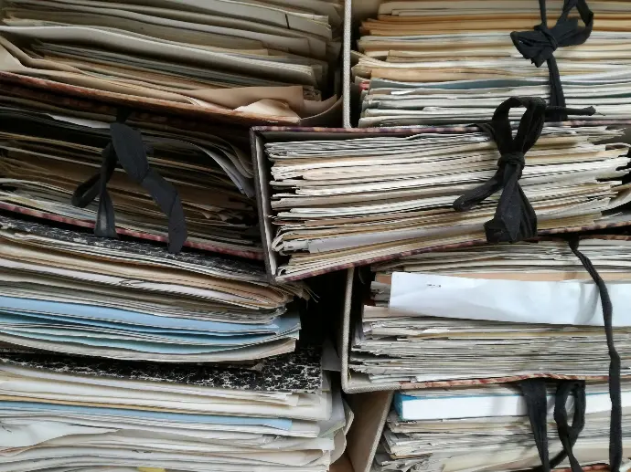Boxed and bundled paper records waiting to be scanned